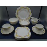retro checked part tea set comprising of a cake serving plate, 5 cake plates 6 saucers, 2 cups,