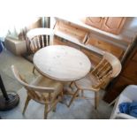 Pine pedestal table and 3 chairs 75cm across.