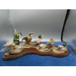 Border Fine Arts group of six mallard ducks on a pebble bank amongst rushes and driftwood, by R