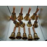 Set of 13 Whitechapel Bell Foundry musical hand bells with leather handles, with book. Bells were