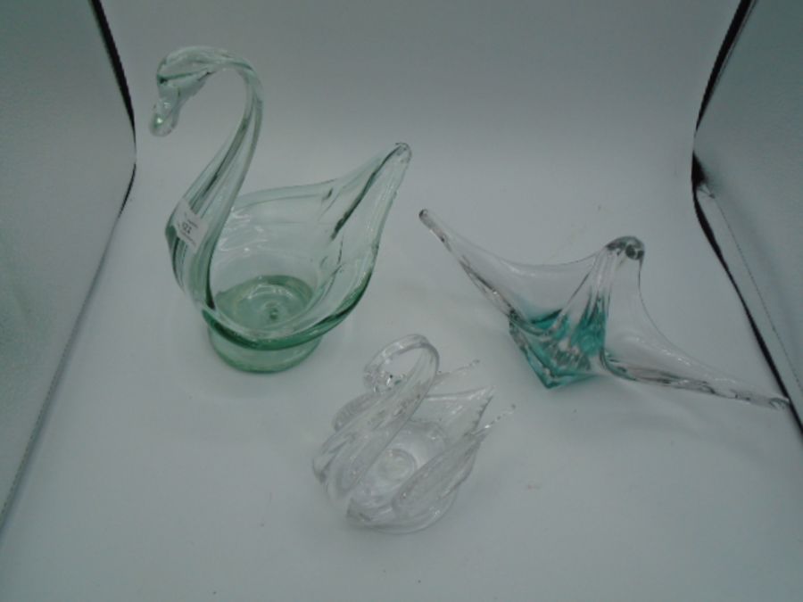 Two glass swan dishes 24cm tall and 15cm tall plus a glass basket with slight green tint at the base