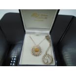 A boxed Daisy pendant on chain marked 925, plus a 'D' charm on a chain