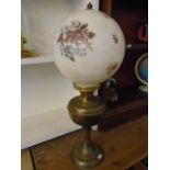 brass base oil lamp with floral decorative globe shade