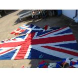 quantity of flags all with mast fixings and length of bunting. The large union jack flag is approx