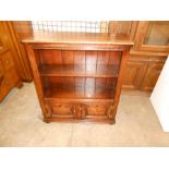 An old charm style bookcase with two cupboard door base, 98cm high x 84cm wide x 26cm deep