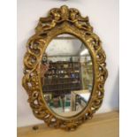 Oval gilt mirror with cherubs