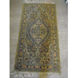 Green 'Persian' style rug with red detail 4ft4" x 2ft 3"