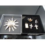 six charms - large sun marked 925, 'D' marked silver, crosses marked 925 and silver, mini teapot