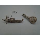 Fine white metal brooches of a banjo and a boat
