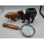 A Victorian camel figure, a treen lion and a magnifying glass