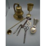 A brass bell, goblet and other metal ware