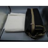 A wine cooler picnic bag and a white tablecloth