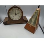 An oak cased mantel clock - no key and a metronome (foot missing)