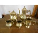 A brass tea set comprising coffee pot, teapot, tankard, milk and sugar bowl