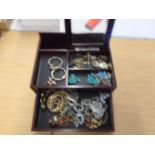 A jewellery box with costume jewellery and a few collectors items
