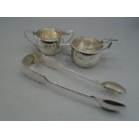 A pair of small silver mustard pots with glass liners and spoons, all hallmarked and a pair of