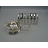 A silver toast rack and tea strainer, both hallmarked. 81 and 69 grams