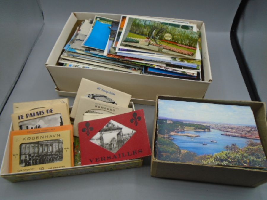 Postcards, a shoe boxes and 2 other small boxes containing postcards, many U.K and around the world.