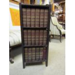 Vintage oak bookcase containing 17 books from the Charles Dickens Library and one other book.