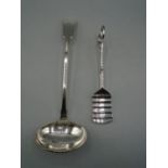 A white metal ladle and a pair of silver plated asparagus tongs. 335g gross weight