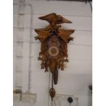 2 Black Forest style cuckoo clocks one large with an eagle and squirrels- hands are off but