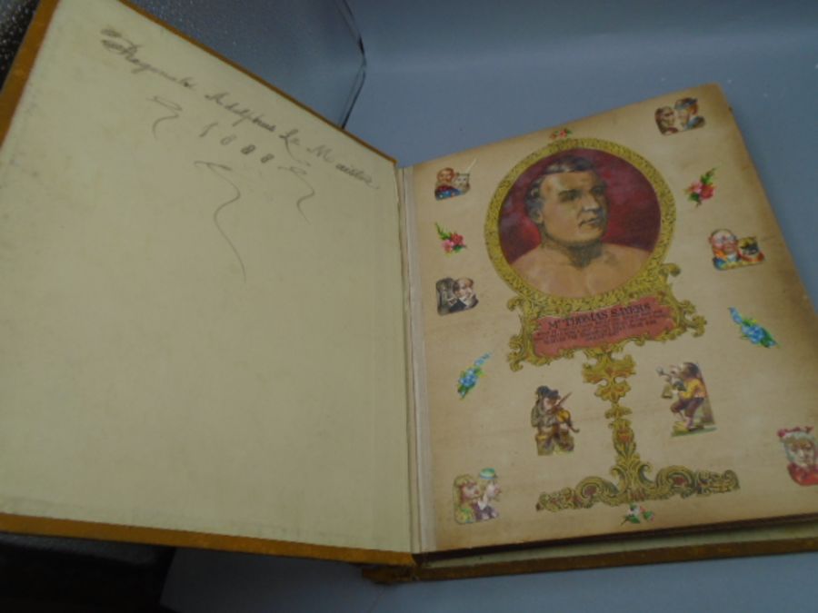 A Victorian scrap book full of cut out pictures