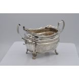 GEORGE III IRISH PROVINCIAL TWO-HANDLED SUGAR BASIN on claw feet with gadrooned borders, by Carden