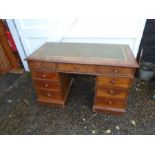 Oak pedestal desk with green leather inlaid top and one central drawer with a further four drawers