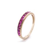 Channel set ruby and 9ct yellow gold ring