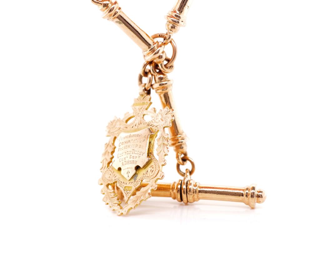 A heavy 9ct rose gold cylinder link fob chain