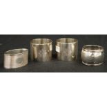 Four various sterling silver napkin rings