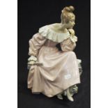 Lladro lady seated with a book and fan figurine