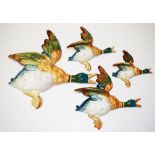 Four graduated Beswick flying ducks