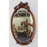 Carved oval wall mirror