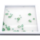 A group of loose mixed cut emeralds