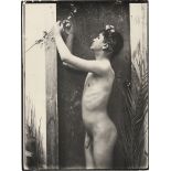 Gloeden, Wilhelm von: Young male nude in doorway with blossom branch