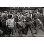 Cartier-Bresson, Henri: French forced laborers beating their former German guard...
