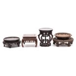 A group of four large Chinese carved hardwood and other stands: 18-26cm wide [4].