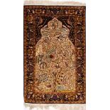 A Kashmir 'silky' rug:, the ivory mihrab with a design of birds amidst a flowering tree,