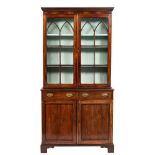 A 19th Century mahogany bookcase:, the upper part with a moulded dentil cornice,