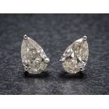 A pair of hallmarked 18ct white gold and pear-shaped diamond single-stone ear studs: each diamond