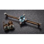 An aquamarine and diamond-set bar brooch: set with a single oval aquamarine and six round old,