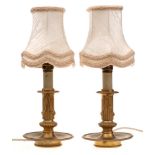 A pair of 19th Century gilt metal table lamps: with fluted and wreath decorated columns,