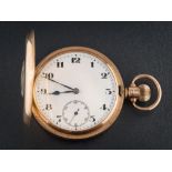 A gentleman's 9ct gold half hunter pocket watch: the white enamelled dial with Arabic numerals and