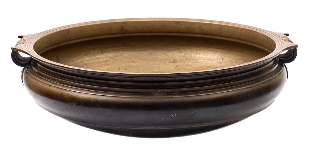 A large Indo- Persian brass brassier/bowl: of circular form, with a moulded edge,