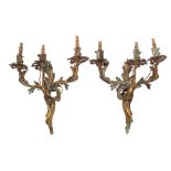 A pair of 19th Century French gilt brass three branch wall lights: with foliate -shaped nozzles,