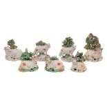 A group of seven Derby porcelain models of sheep: including a pair,