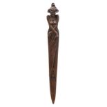 An Art Nouveau period bronze paper knife: in the form of a semi nude female draped in robes,