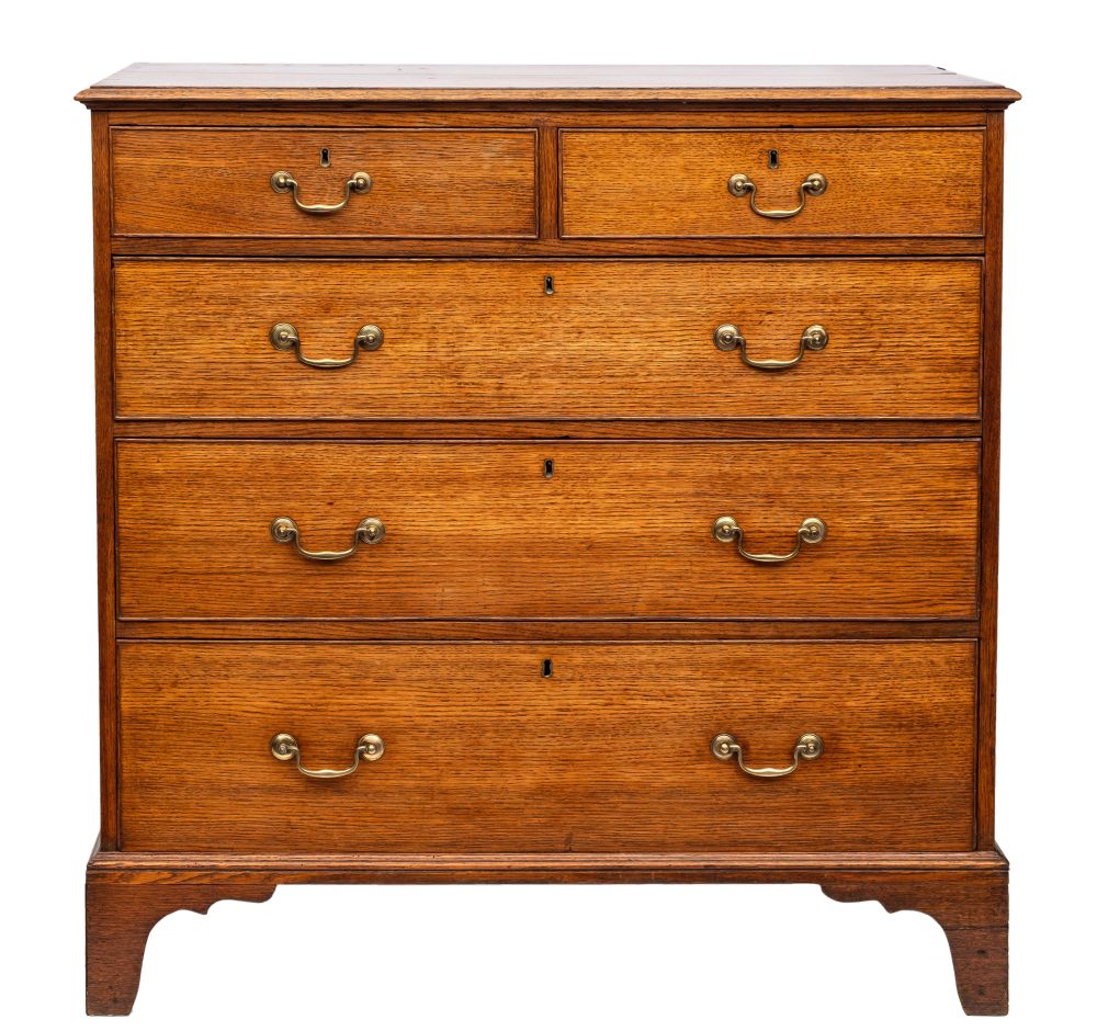 An 18th century oak rectangular chest: the top with a moulded edge,