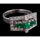 A platinum, emerald and diamond rectangular cluster ring in the Art Deco style.